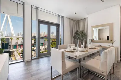 a dining room with a table and views of the city at Luxury 3 Bedroom Apartment in Bluewaters Residences in Dubai