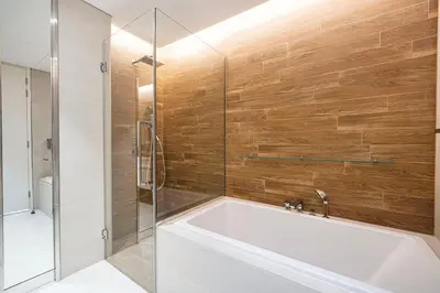 a bathroom with a tub and a glass shower at Luxury 3 Bedroom Apartment in Bluewaters Residences in Dubai