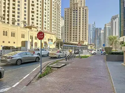 a stop sign on the side of a street with cars at 70m2 Bay Central-Luxury One Bedroom with Spectacular Marina Views in Dubai