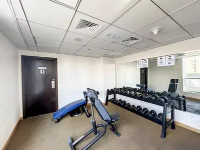 a room with a gym with weights and a treadmill at 70m2 Bay Central-Luxury One Bedroom with Spectacular Marina Views in Dubai