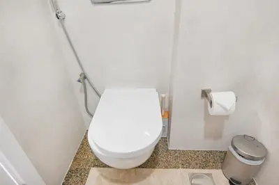 a bathroom with a white toilet and a trash can at 70m2 Bay Central-Luxury One Bedroom with Spectacular Marina Views in Dubai