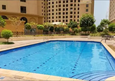 a large swimming pool in the middle of a building at Premium 1BR With Stunning Marina & Sea Views in Dubai