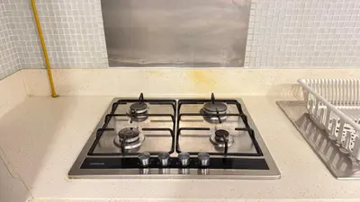 a stove top oven sitting on top of a kitchen counter at DAMAC - Bays Edge 1BR - Burj Khalifa Views & Pool in Dubai