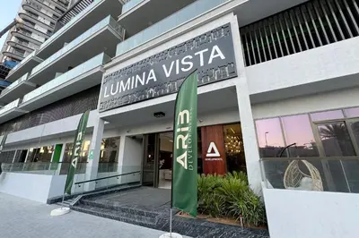 a building with a sign that reads liima vista at Brand New Grand 2BR Duplex apartment in Jumeirah Village Circle with Pool, Gym and kids playground in Dubai