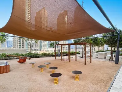 a playground with tables and a swing at Downtown Comfort Spacious 1BR in Burj Royale in Dubai