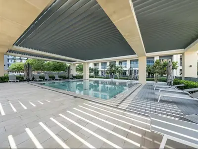 a swimming pool in a building with chairs and a building at 1BR in Emaar Burj Royale - 1min walk to Fountain&Dubai Mall, Burj view Pool & gym in Dubai