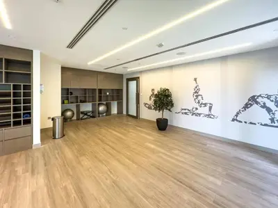 an empty room with a potted plant in the middle at 1BR in Emaar Burj Royale - 1min walk to Fountain&Dubai Mall, Burj view Pool & gym in Dubai