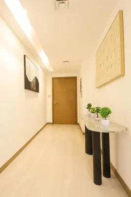 a hallway with a table in the middle of a room at Spacious 2BR in Missoni - Canal Views - Near Metro in Dubai