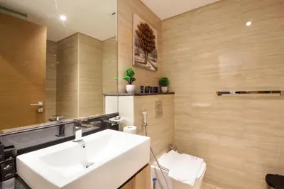 a bathroom with a sink and a toilet at Spacious 2BR in Missoni - Canal Views - Near Metro in Dubai