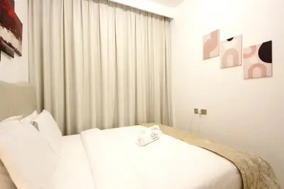 a bedroom with a white bed with a white blanket at Spacious 2BR in Missoni - Canal Views - Near Metro in Dubai