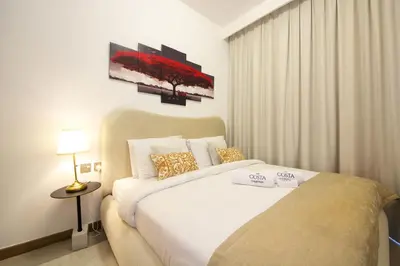 a bedroom with a large white bed in a room at Spacious 2BR in Missoni - Canal Views - Near Metro in Dubai