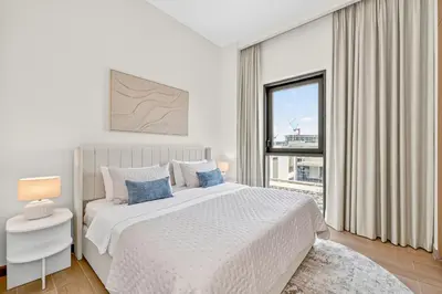 a white bedroom with a large bed and a window at New 3BD in Grove Creek Beach with Stunning View in Dubai
