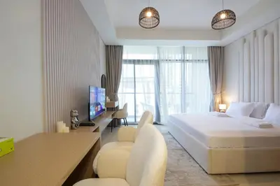 a hotel room with a bed and a desk and chair at Luxury Studio in Aykon Tower - Pool & Gym Access in Dubai