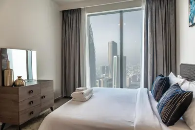 a bedroom with a bed with a large window at Exotic 2 bed downtown Burj Khalifa dist Dubai mall in Dubai