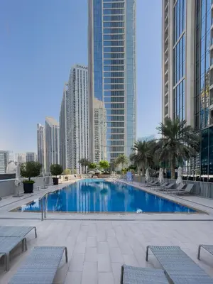 a pool in the middle of a city with tall buildings at Exotic 2 bed downtown Burj Khalifa dist Dubai mall in Dubai