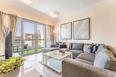 a living room with a couch and a table at 1BR Near Burj Khalifa and Dubai Mall, Easy Access to Dubai Marina and Palm Jumeirah by Road or Metro, BLVD Walk, Downtown Dubai by Deluxe Holiday Homes in Dubai