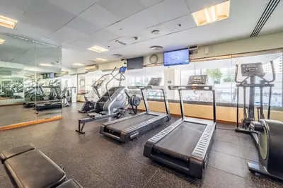 a gym with treadmills and elliptical machines at 1BR Near Burj Khalifa and Dubai Mall, Easy Access to Dubai Marina and Palm Jumeirah by Road or Metro, BLVD Walk, Downtown Dubai by Deluxe Holiday Homes in Dubai