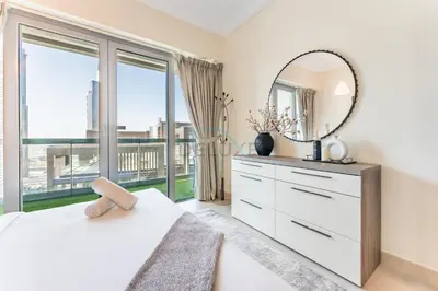 a bedroom with a mirror and a white dresser at 1BR Near Burj Khalifa and Dubai Mall, Easy Access to Dubai Marina and Palm Jumeirah by Road or Metro, BLVD Walk, Downtown Dubai by Deluxe Holiday Homes in Dubai