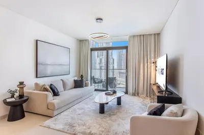 a living room with a couch and a table at Downtown Luxury 2 Bed Apartment in Dubai