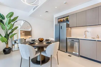 a kitchen with a table and chairs and a sink at Downtown Luxury 2 Bed Apartment in Dubai