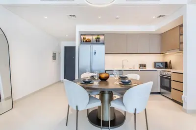 a kitchen and dining room with a table and chairs at Downtown Luxury 2 Bed Apartment in Dubai