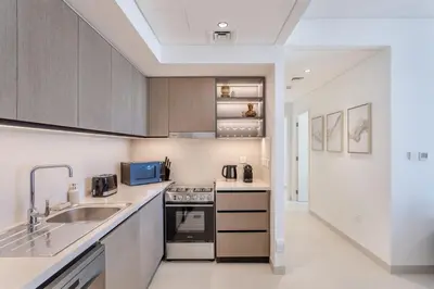a kitchen with a sink and a stove at Downtown Luxury 2 Bed Apartment in Dubai
