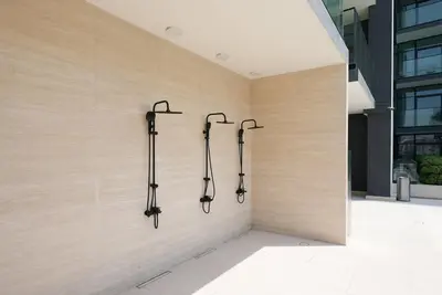 a wall with four hoses in a building at JVC - Designer 2 BHK apartment - Pool&Gym - by MKB LIVING in Dubai