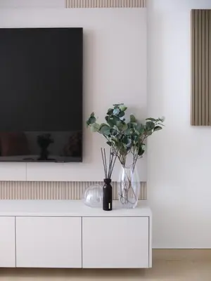 a white cabinet with a tv on top of it at JVC - Designer 2 BHK apartment - Pool&Gym - by MKB LIVING in Dubai