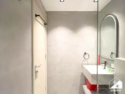 a bathroom with a shower and a sink and a mirror at Relaxing ST Getaway l Balcony, Pool & Gym Access in Dubai