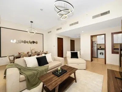 a living room with a couch and a table at Jumeirah Beachfront with Ain View and Sea View 2BR in Dubai