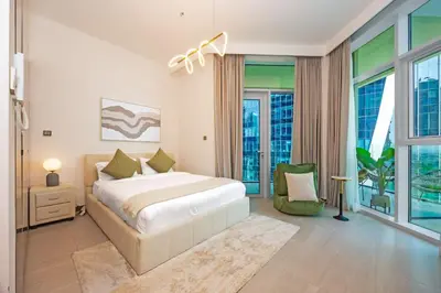 a bedroom with a bed and a large window at Luxury Studio Retreat Canal View and City Life in Dubai