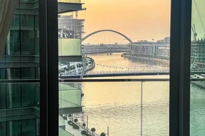 a view of a river and a bridge from a building at Cozy 2BR APT With Canal Views, Pool with Burj View in Dubai