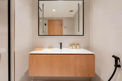 a bathroom with a sink and a mirror at TRPS - Marquise Square, Business Bay - Burj Khalifa View, Spacious Studio, Fully Furnished in Dubai