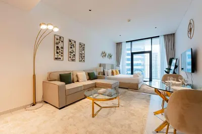 a living room with a couch and a table at TRPS - Marquise Square, Business Bay - Burj Khalifa View, Spacious Studio, Fully Furnished in Dubai