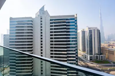 a view of a tall building in a city at TRPS - Marquise Square, Business Bay - Burj Khalifa View, Spacious Studio, Fully Furnished in Dubai