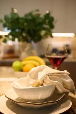 a bowl of nuts and a glass of wine on a table at Luxury 1BR Apt Dowtown Dubai Imperial Avenue with Burj Khalifa Views in Dubai