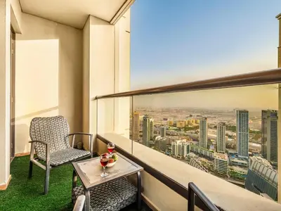 a balcony with a table and a chair and a view at JBR Beachfront with Full Sea and Ain Dubai View in Dubai