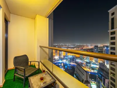 a balcony with a view of a city at night at JBR Beachfront with Full Sea and Ain Dubai View in Dubai