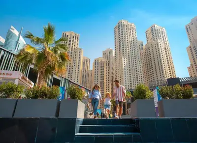 a group of people walking down stairs in a city at JBR Dubai VIP Lux Penthouse priv Pool cinema Limo tranfer-housekeeper in Dubai