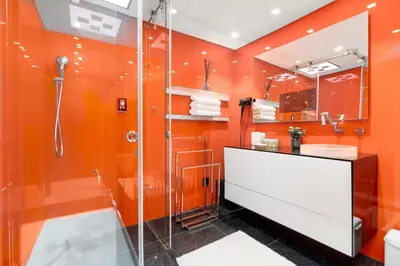 an orange bathroom with a shower and a sink at JBR Dubai VIP Lux Penthouse priv Pool cinema Limo tranfer-housekeeper in Dubai