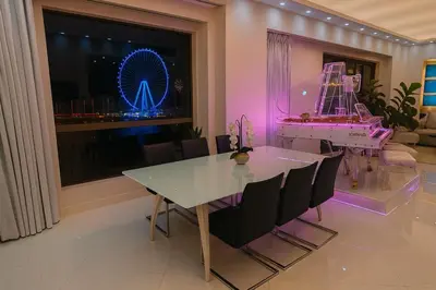 a dining room with a table and a ferris wheel at JBR Dubai VIP Lux Penthouse priv Pool cinema Limo tranfer-housekeeper in Dubai
