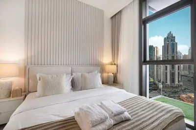 a bedroom with a large bed and a large window at Mahogany 18 - 2BR 10 Guests - Walk to Dubai Mall in Dubai