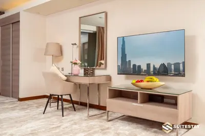 a room with a desk and a television and a chair at Suitestay-Fahion Avenue Dubai mall in Dubai
