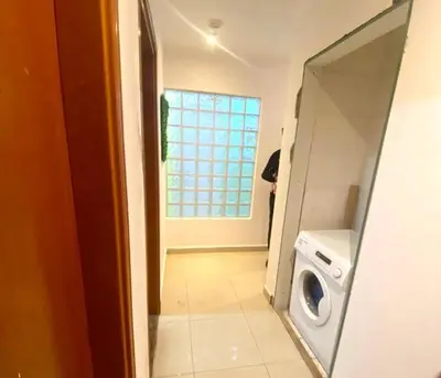 a laundry room with a washing machine and a window at Private Double Room In Barsha Heights Near Metro in Dubai