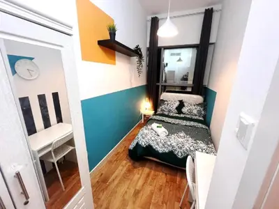 a small room with a bed and a mirror at The Cozy Classic Room In Barsha Heights ICM Metro in Dubai