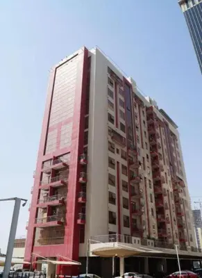 a tall building with cars parked in front of it at Furnished Partiton Room in Tecom Barsha Heights Near ICM Metro in Dubai