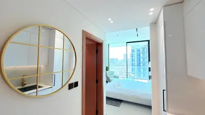 a bedroom with a large mirror and a bed at Premium Studio In Jvc Bazr in Dubai