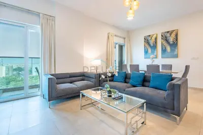 a living room with two couches and a table at Balcony Overlooking the Community, Quick Metro Access,Short 15-Minute Drive to Ibn Battuta Mall, Viktoria Residency, Al Furjan by Deluxe Holiday Homes in Dubai