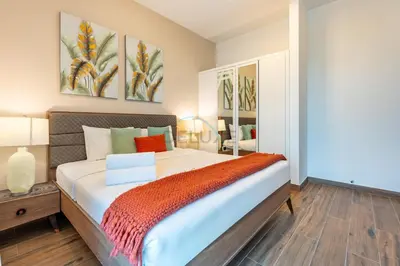 a bedroom with a large bed in a room at Balcony Overlooking the Community, Quick Metro Access,Short 15-Minute Drive to Ibn Battuta Mall, Viktoria Residency, Al Furjan by Deluxe Holiday Homes in Dubai