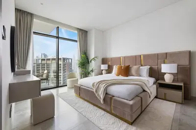 a bedroom with a large bed and a large window at 1BR with Direct Burj Khalifa View in Dubai